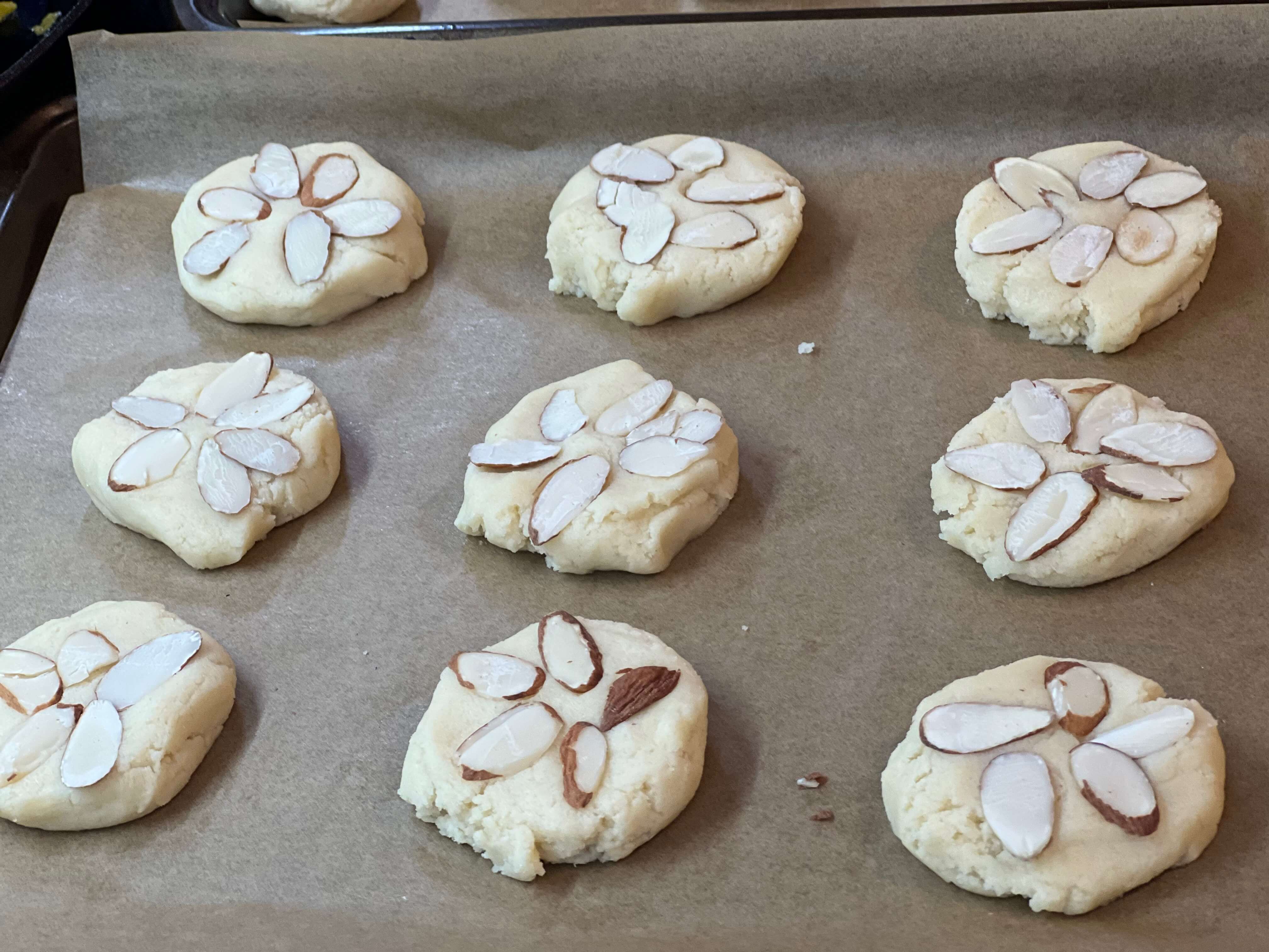 Place slivered almonds on tops of the pressed down cookie dough.