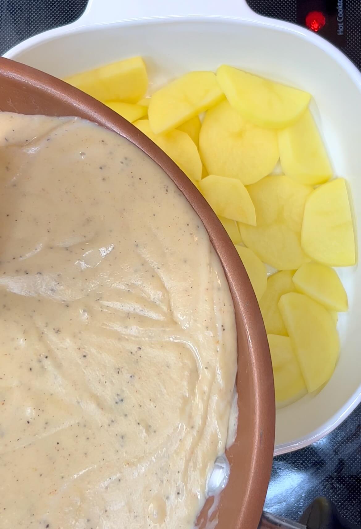 Add cheese sauce to first layer of sliced potatoes.