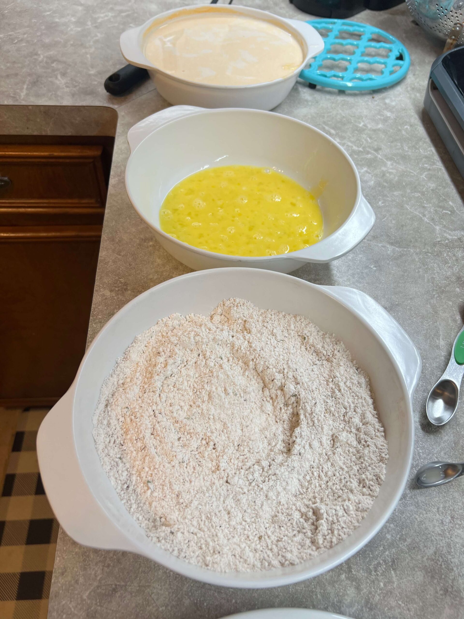 Ready to batter your chicken; buttermilk, flour mixture, egg, and then mixture again.