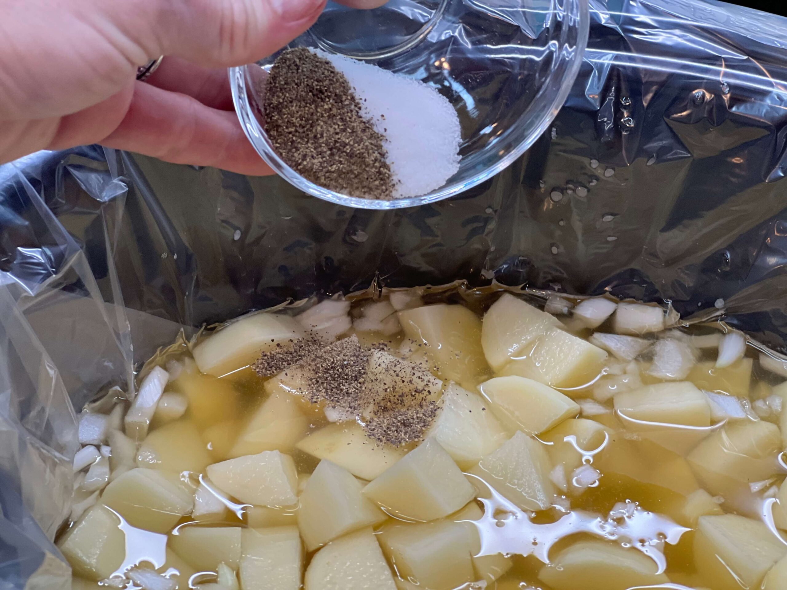 Add salt and black pepper to the slow cooker.