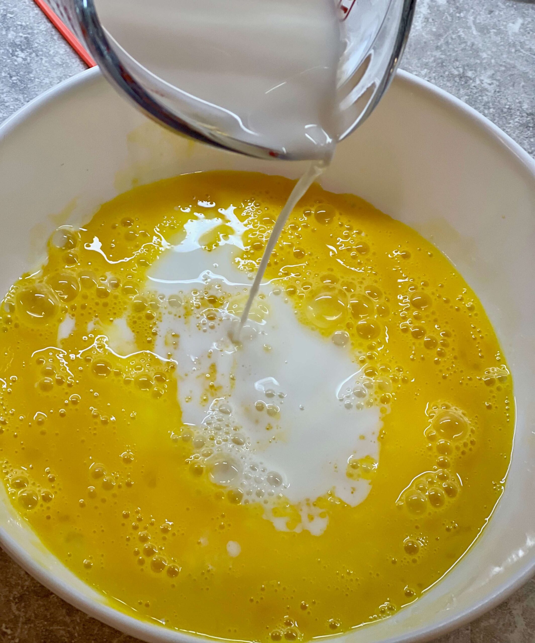 Add milk to the whisked eggs.