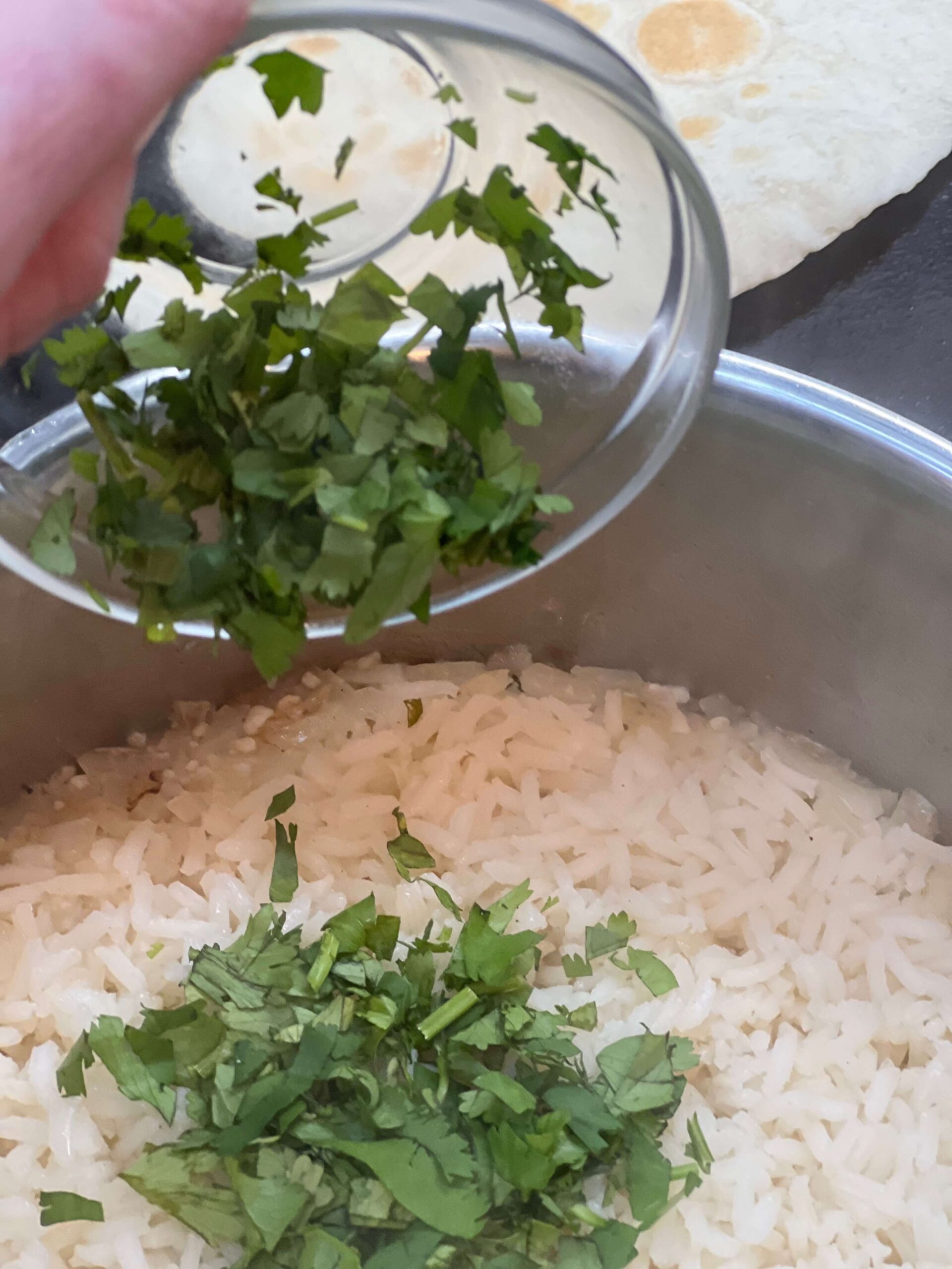 Add cilantro to cooked rice.