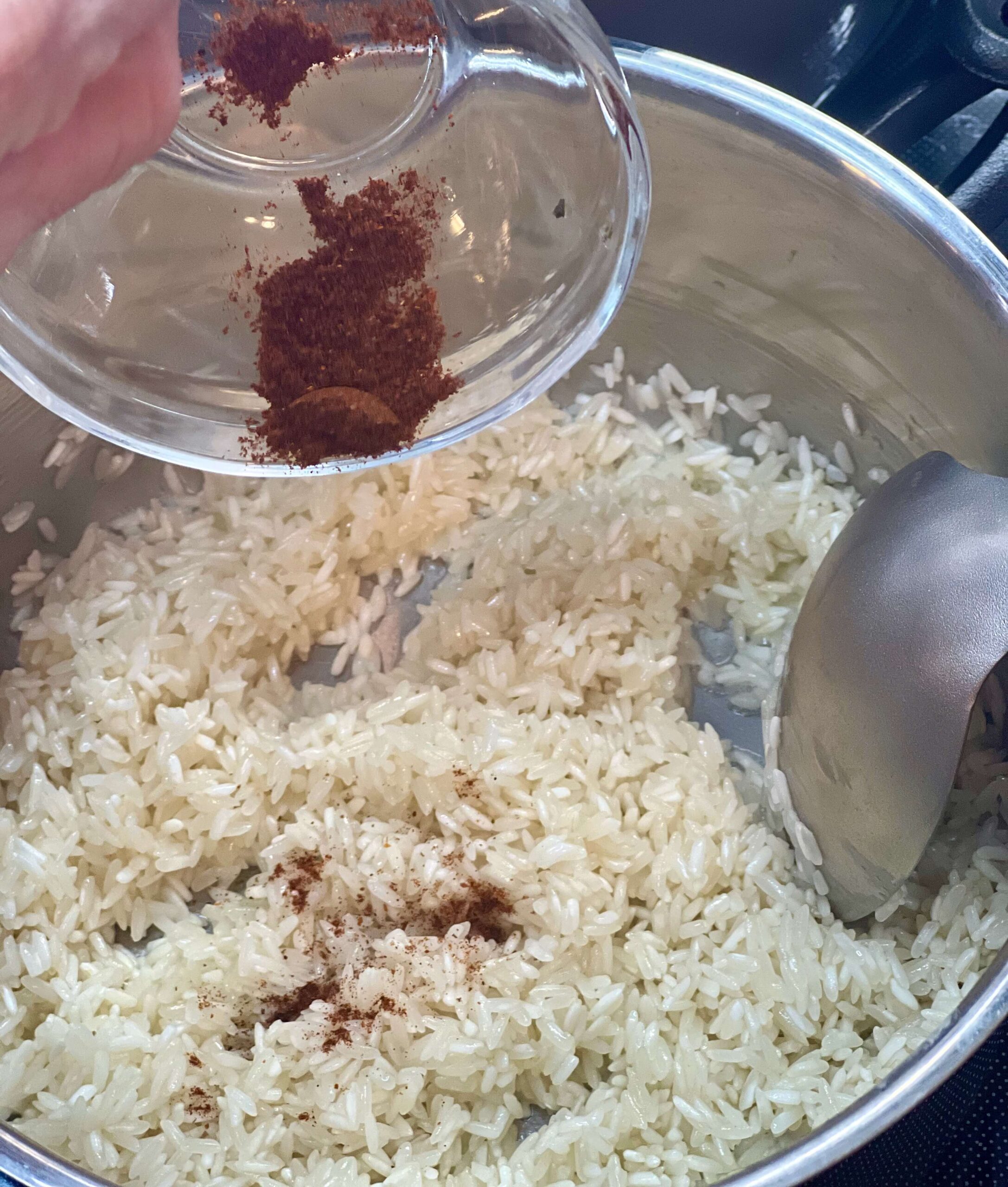 Begin adding your spices for your Southwest rice