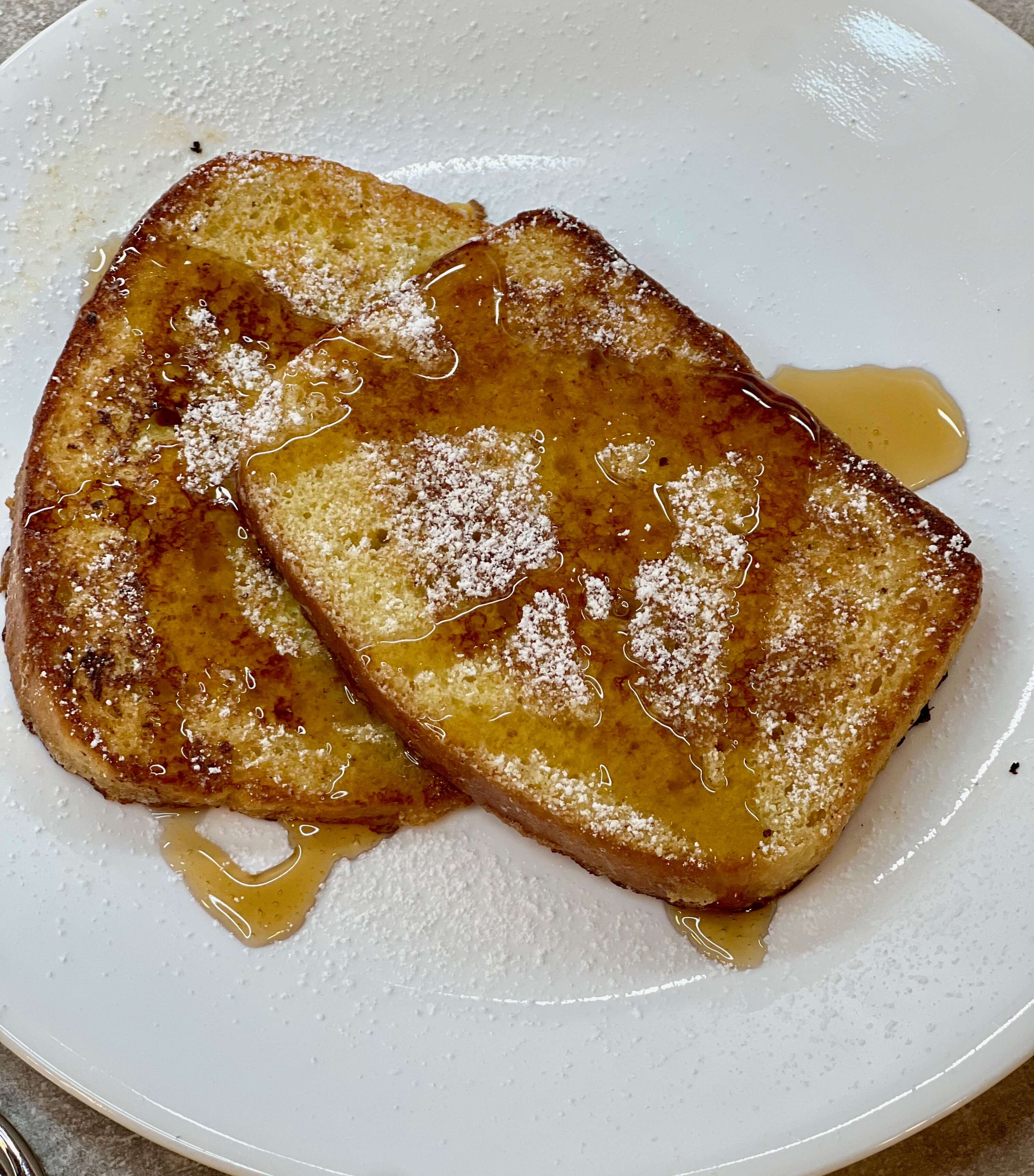 Finished French Toast with syrup and powdered sugar